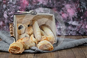 Cookies in a metallic container on the white towel