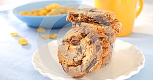 cookies with milk on a blue background. american chocolate chip cookie closeup. pastries on the table. sweets on a plate