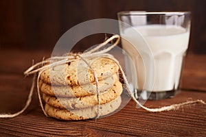 Cookies and milk. Chocolate chip cookies and a glass of milk. Vintage look. Tasty cookies and glass of milk