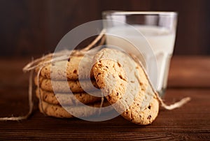 Cookies and milk. Chocolate chip cookies and a glass of milk. Vintage look. Tasty cookies and glass of milk