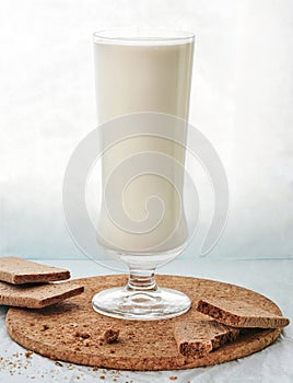 Cookies and milk drink in a tall glass on the table
