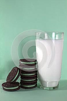 Cookies and milk on a green background