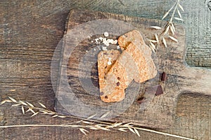 Cookies muesli made with raw organic cereals rice flour with chocolate on old wooden cutting Board.