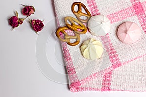 Cookies, murhmellows, dry roses on tablecloth, tasty photo