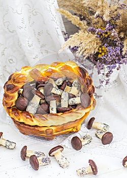 Cookies mushrooms glazed in white and brown chocolate in wicker basket of dough. Dessert. Beautiful