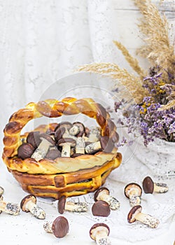 Cookies mushrooms glazed in white and brown chocolate in wicker basket of dough. Dessert. Beautiful