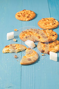 Cookies with nuts and lump sugar on blue wooden table/cookies with nuts and lump sugar on blue wooden table freshly baked.