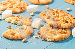 Cookies with nuts and lump sugar on blue wooden table/cookies wi