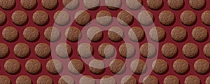 Cookies pattern on the dark red background, continous background. Top view of chocolate chip cookies. Cookies with protein,