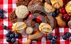 Cookies and sand biscuit on tier cake stand with blueberry chocolate