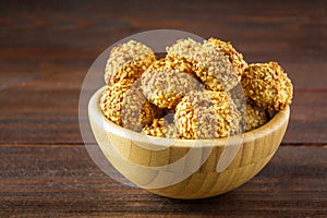 cookies with sesame seeds on a wooden table.