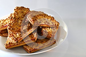 Cookies with strawberry jam on a white plate