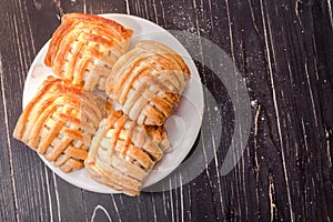 Cookies and sweet pastries with cross wired lines in white plate. Top view