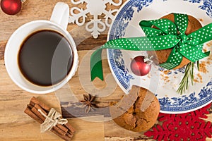 Cookies tied with green ribbon and Christmas decoration, on wooden surface.