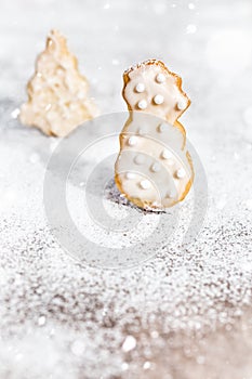 Cookies which snowman and christmas tree shape, icing sugar and