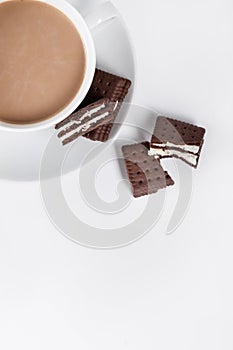 Cookies on white plate and cup of coffee