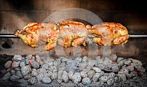 Cooking 3 rotisserie chicken on the grill with Charcoal and Briquettes