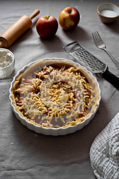 Cooking apple pie pastry. Raw pie with red apples in baking tin