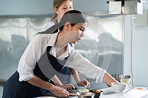 Cooking apprentices prepare meals and ingredients before the chef arrives to instruct