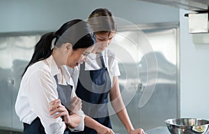 Cooking apprentices prepare meals and ingredients before the chef arrives to instruct photo