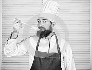 Cooking as professional occupation. Hipster bearded chef hold wooden spoon. Kitchenware and cooking concept. Lets try