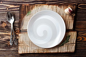 Cooking background concept. Vintage cutting board, plate and cutlery