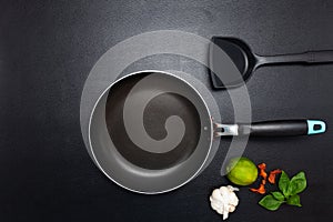 Cooking background Top view frying pan and pot on black leather table background