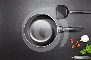 Cooking background Top view frying pan and pot on black leather table background