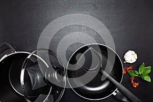Cooking background Top view frying pan and pot on black leather table background