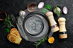 Cooking background. Vegetables, spices and kitchen utensils on a stone background.