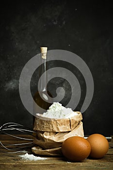 Cooking and baking background. Old kitchen with products and ingredients flour, butter, eggs for dough and baking bread, pasta