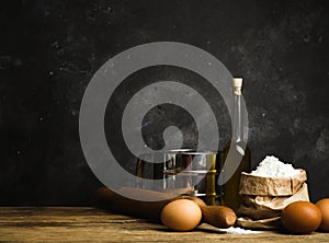 Cooking and baking background. Old kitchen with products and ingredients flour, butter, eggs for dough and baking bread, pasta