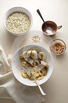 Cooking banana and peanut butter cookies. Top view of ingredients bananas, oatmeal, peanut butter