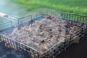 Cooking barbecue chicken on the grill. Close-up