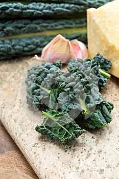 Cooking with black flat leaves of cavolo nero tuscan cabbage