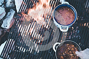 Cooking on bonfire: Tasty stew on a camping trip