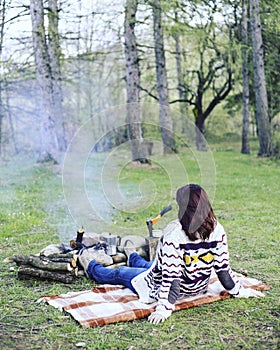 Cooking breakfast on a campfire at a summer camp.