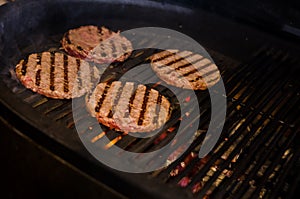 Cooking burgers on hot grill. barbecue. grilling