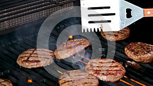 Cooking burgers on a hot grill with a flame Beef cutlets cooked on a barbecue grill.Cooking beef and pork patty for