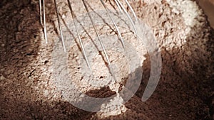 Cooking cake. Mixing flour and cocoa powder in bowl. Close-up.