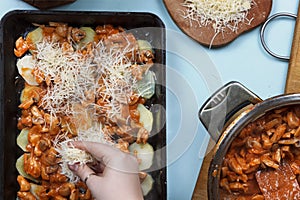 Cooking casserole in a stewpan. Preparation of home-made cake with stuffing. Woman cook puts a stuffing in roasting tin.