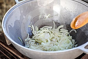 Cooking in a cauldron. Fries onions in a hike