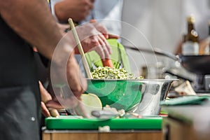 Cooking. Chef is cutting greens in the kitchen