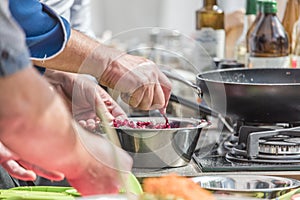 Cooking. Chef is cutting greens in the kitchen