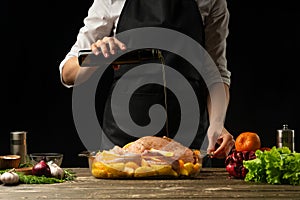 Cooking chef duck, chicken, turkey with fruit for the holiday, horizontal photo, black background