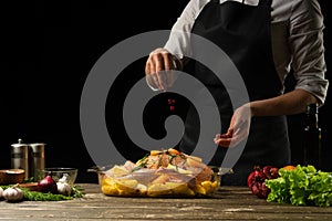 Cooking chef duck sprinkle with grains of pomegranate frozen, horizontal photo, black background