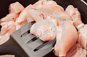 Cooking chicken breast for muscle recovery. Poultry meat on a plastic kitchen spatula