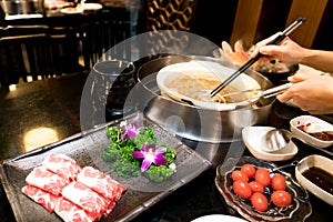 Cooking Chinese shabu with cherry tomato and yummy beef meat