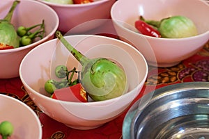 Cooking class: Thai, pea eggplants, red chilies in bowls