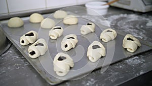 cooking. close-up. bakery. making dough pies. Close-up. raw yeast dough pies with sweet filling, laid out on a metal